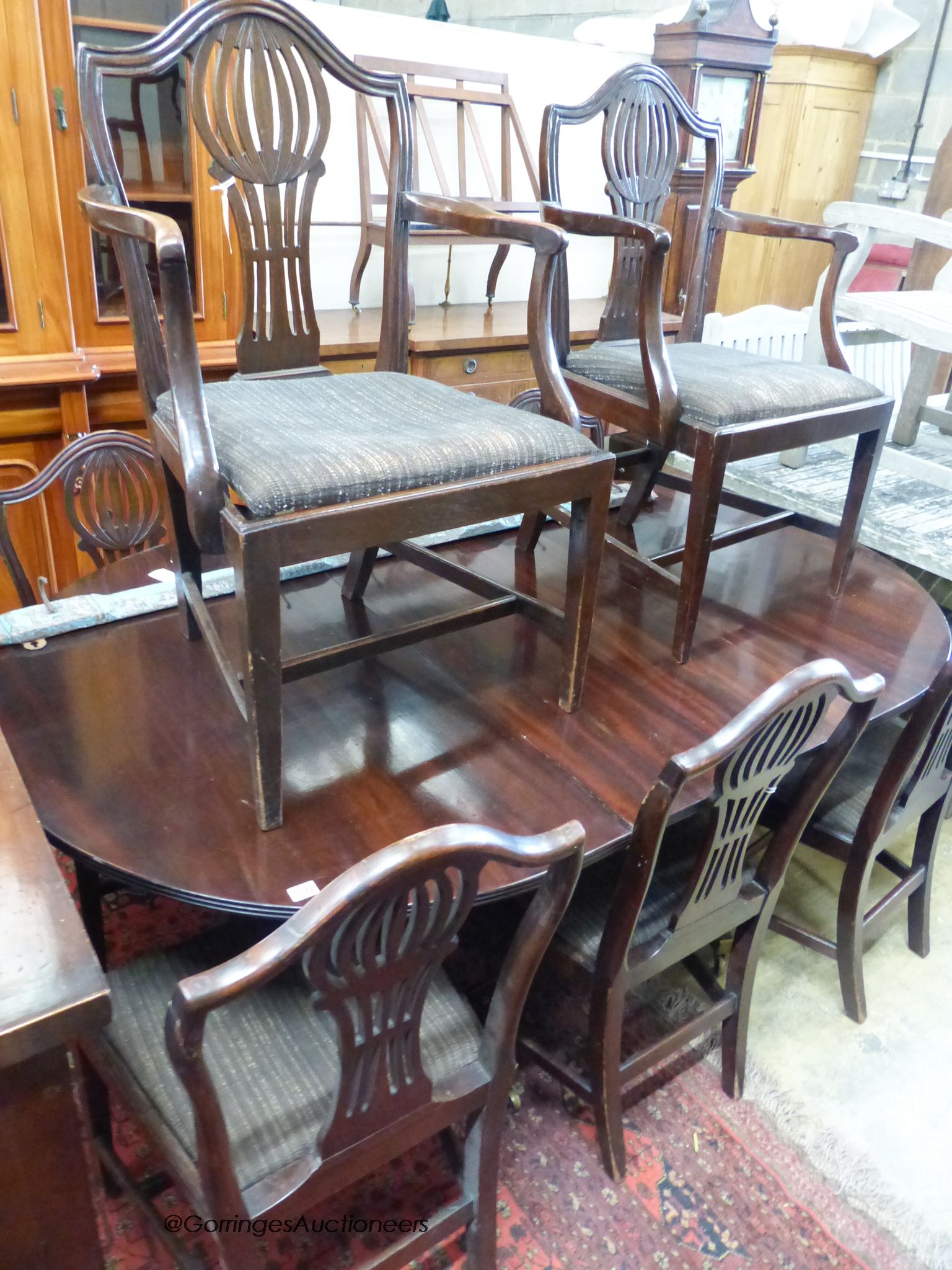A set of eight Hepplewhite style mahogany dining chairs (two having arms)